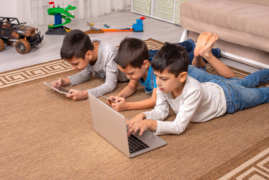 Children of different ages use gadgets for games, communication