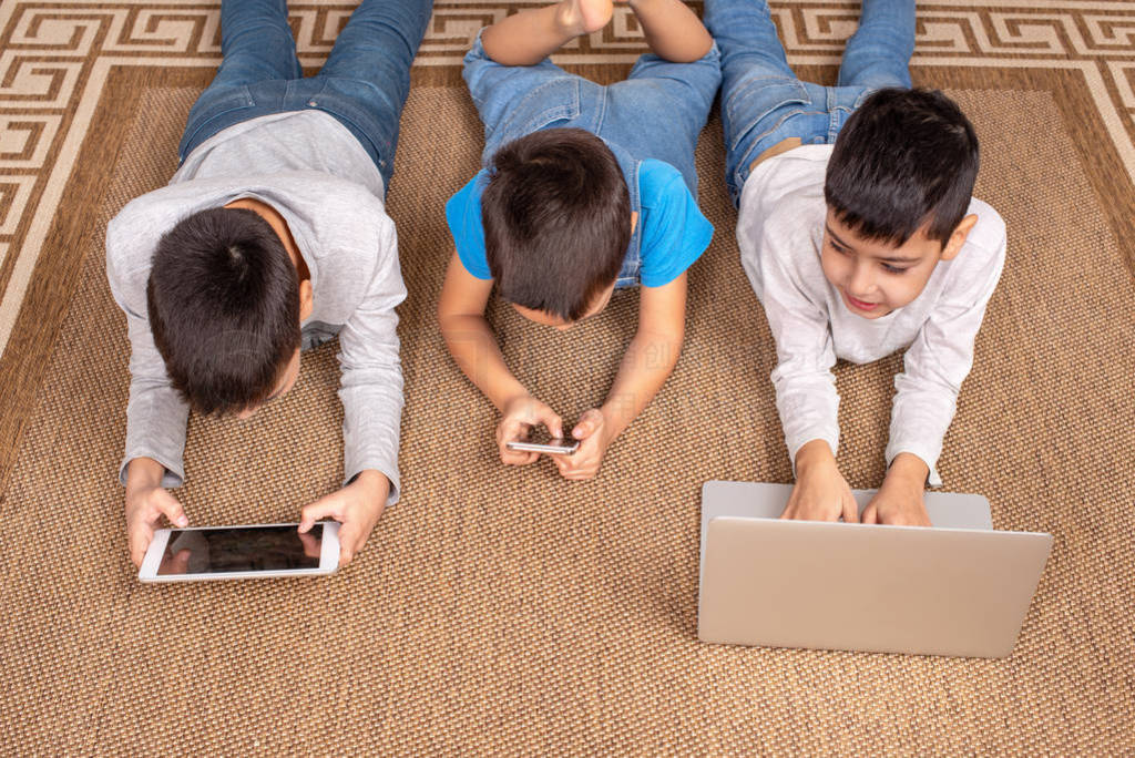 Children of different ages use gadgets for games, communication