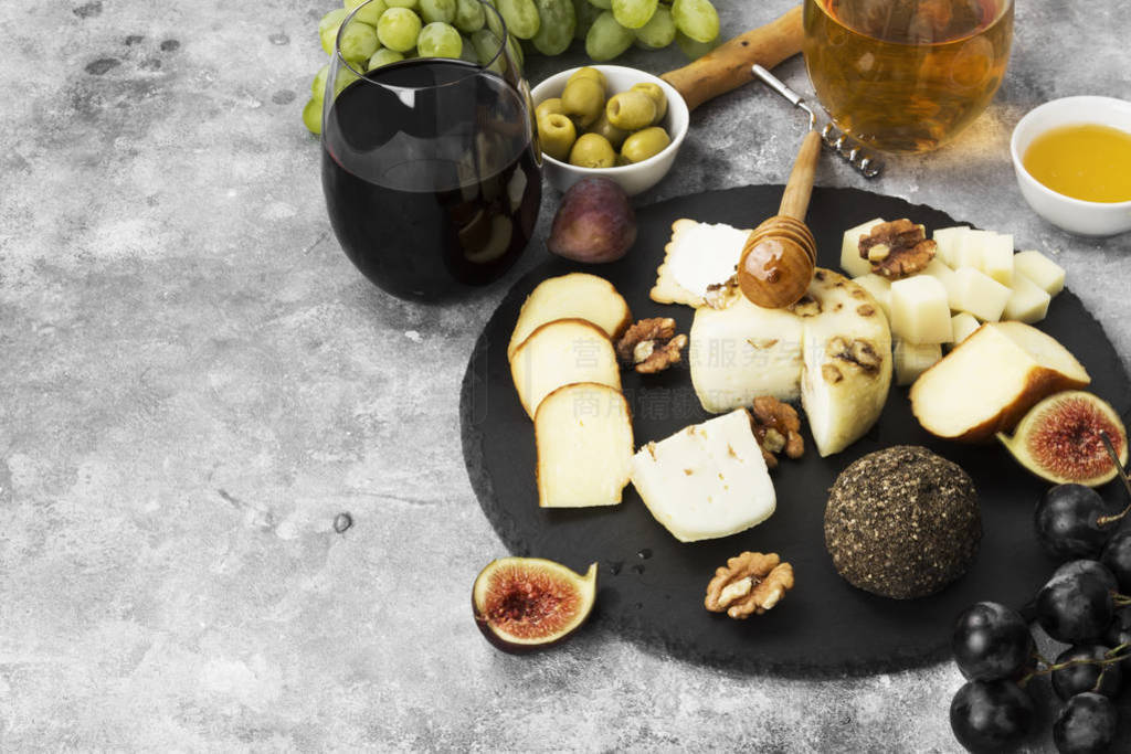 Snacks with wine - various types of cheeses, figs, nuts, honey,