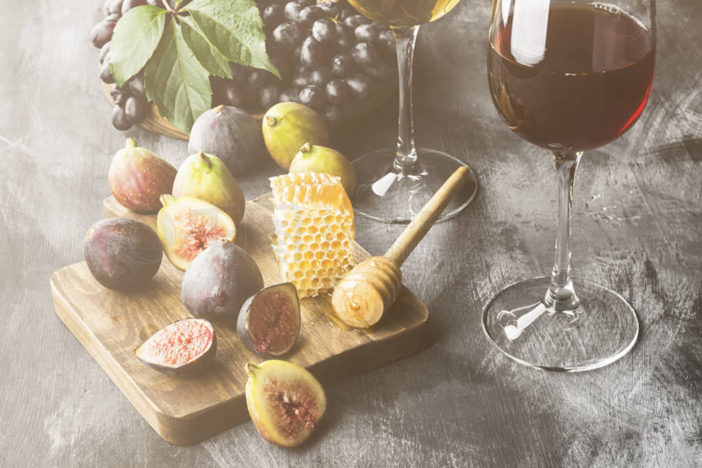 Various snack - fig, grapes, bread, honey to red and white wine