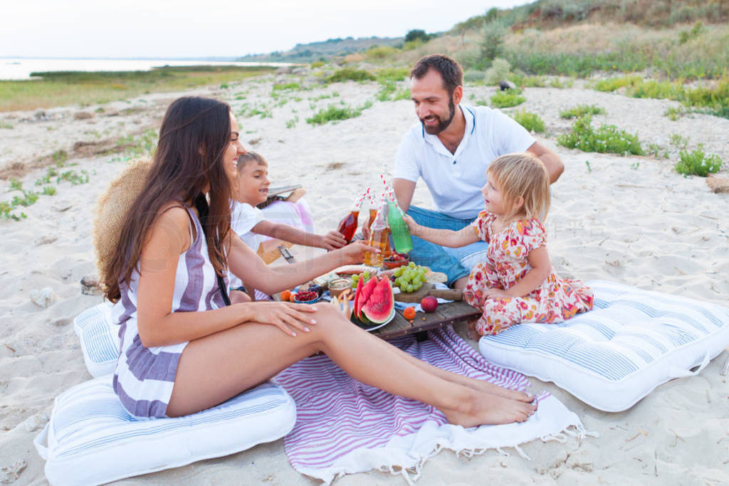 Picnic on the beach at sunset in the style boho, food and drink