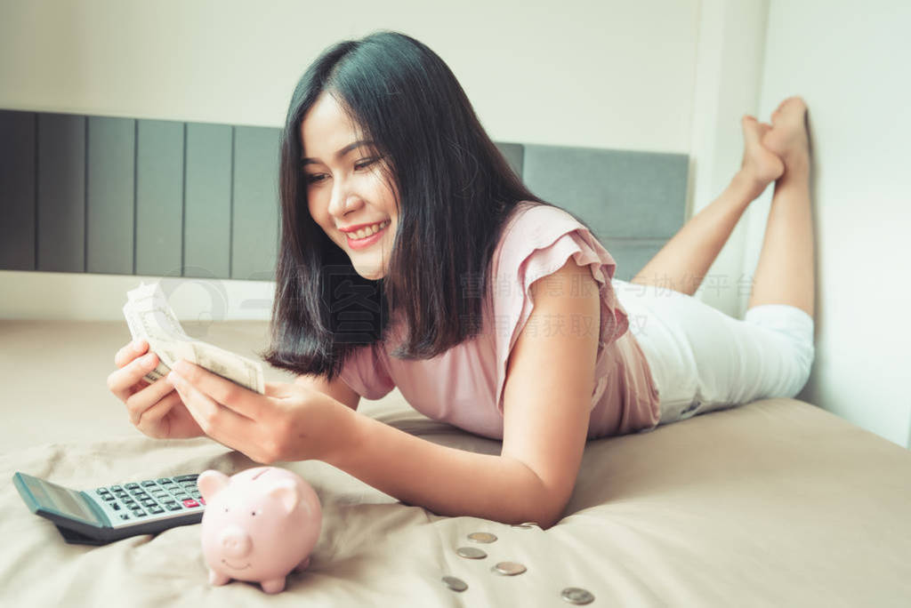 Portrait of Beautiful Woman is Calculating Money Saving While Ly