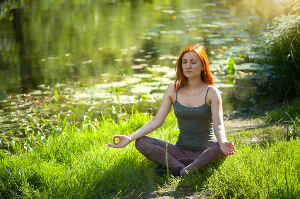 Yoga woman meditating at sunset. Women's model of meditation in