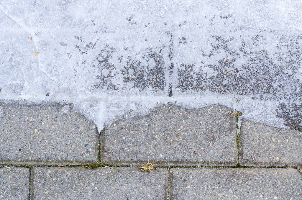 Paving slabs on walkway with ice.