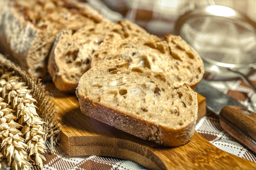 loaf of bread on wooden background, food closeup.Fresh homemade