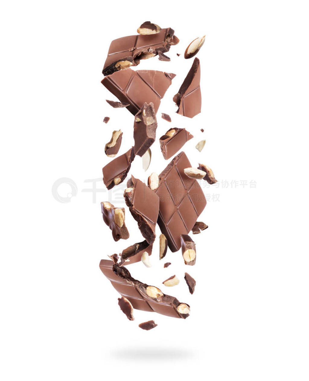 Pieces of broken chocolate falling down on white background