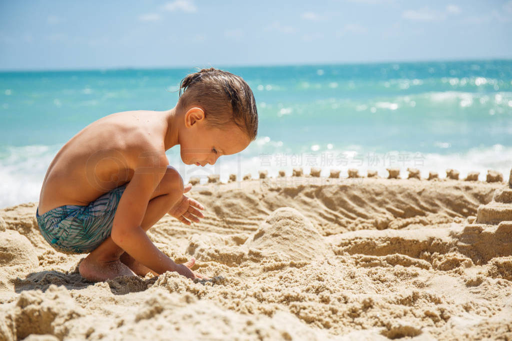 little boy built a sand castle