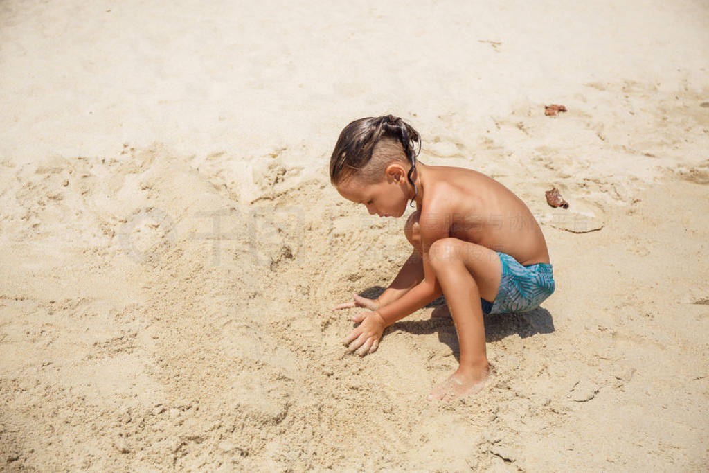 little boy built a sand castle