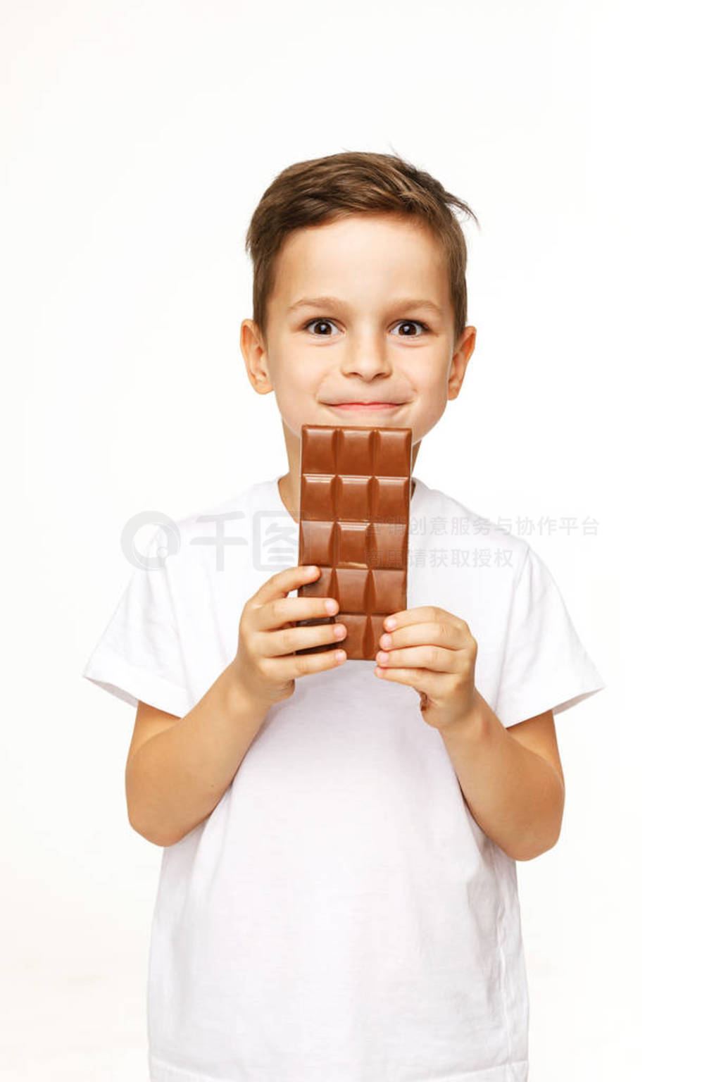 little beautiful boy holding chocolate studio shot