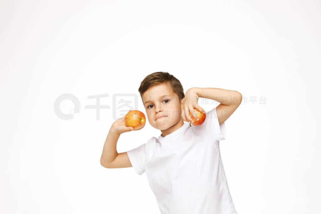 Little boy is holding apples studio shot