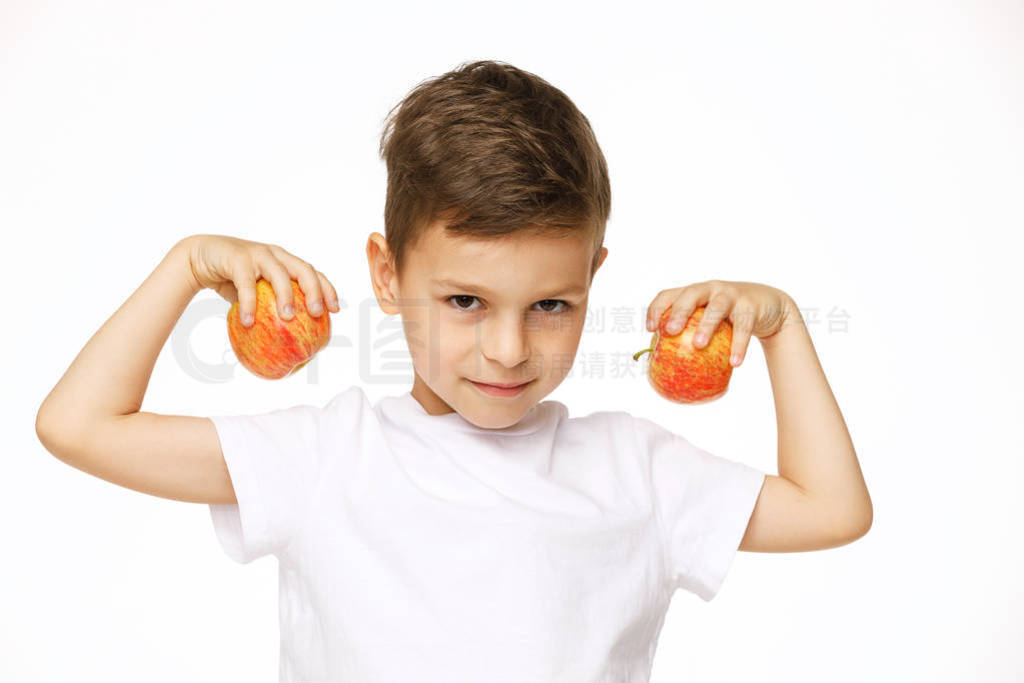 Little boy is holding apples studio shot