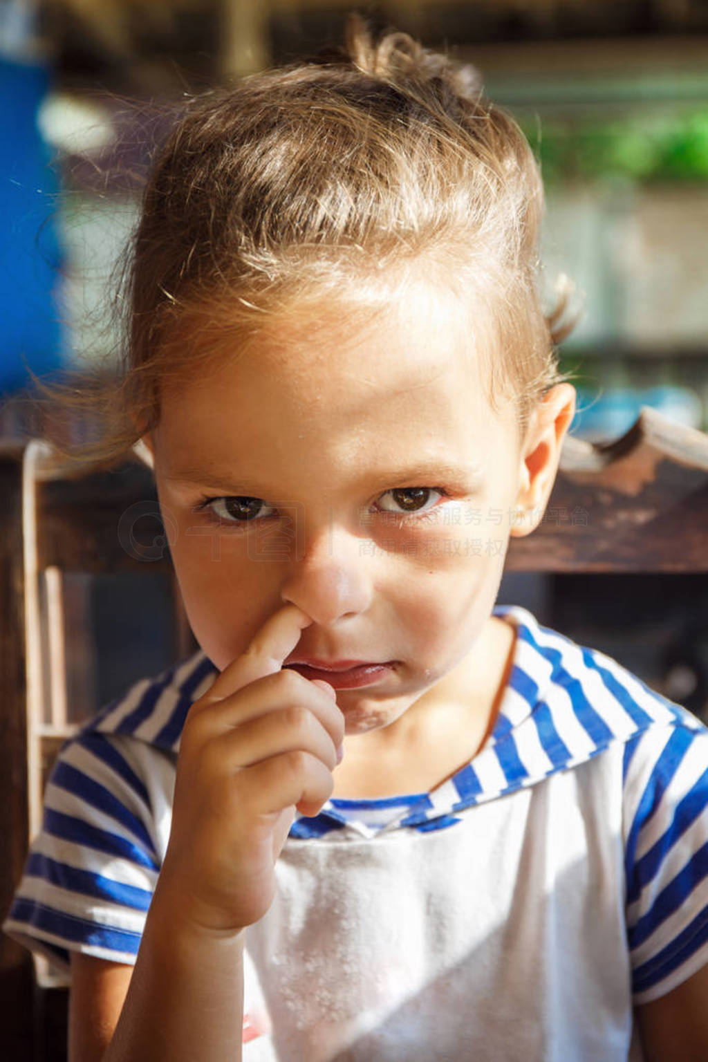 Little boy picks his nose at Breakfast