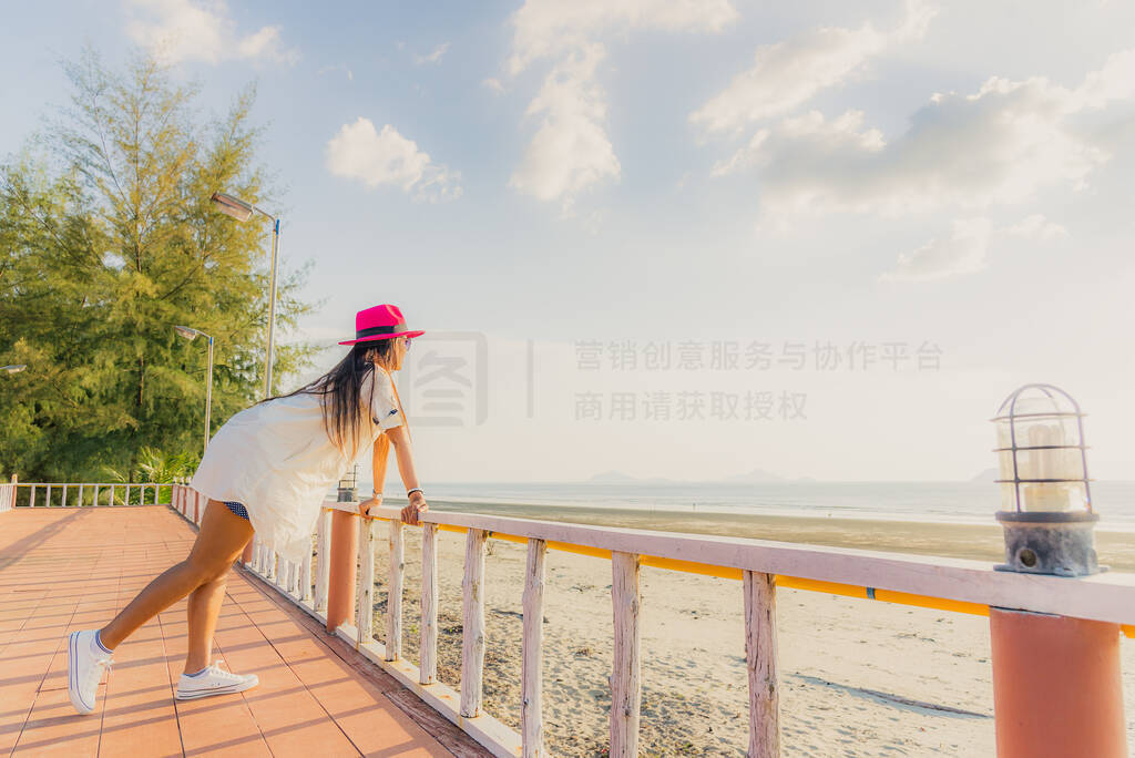 Traveler Asian woman joy relaxing on terrace of resort in front
