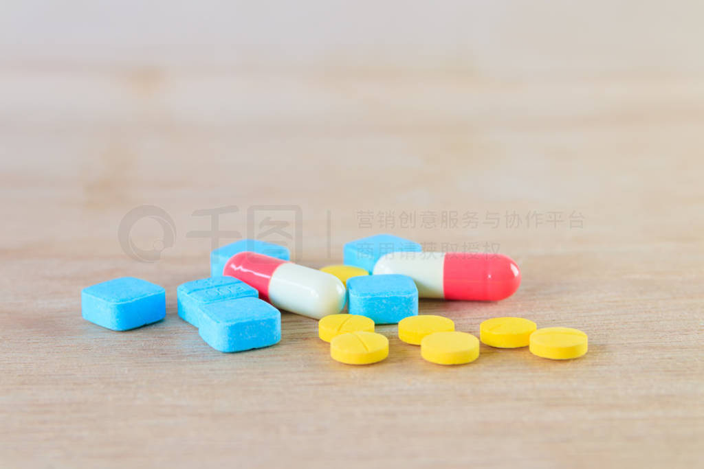 pills and capsule On wooden floor with copy space add text