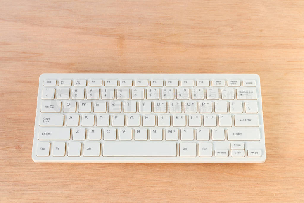 computer keyboard white on wooden floor