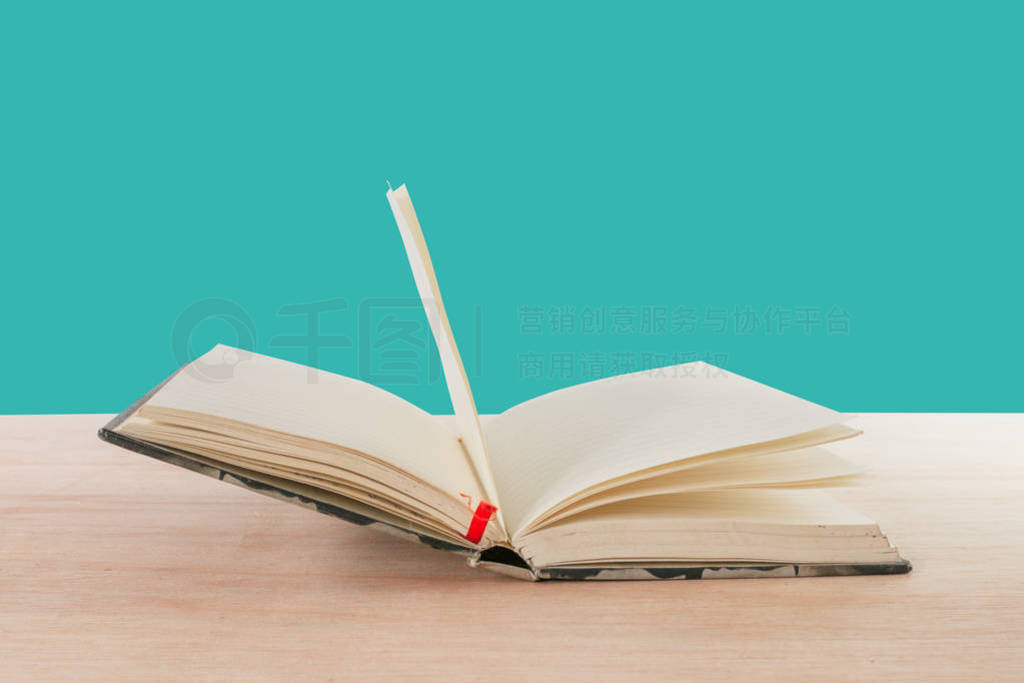 open book old on wooden floor isolated on blue background