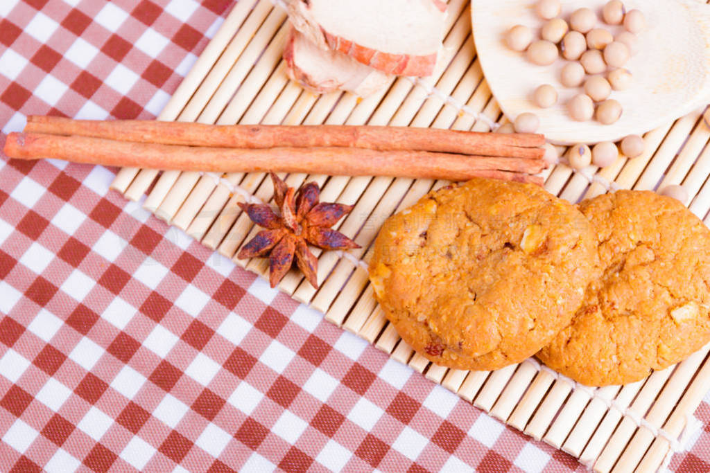 cereal cookies with spoon spice on wooden bamboo and tablecloth