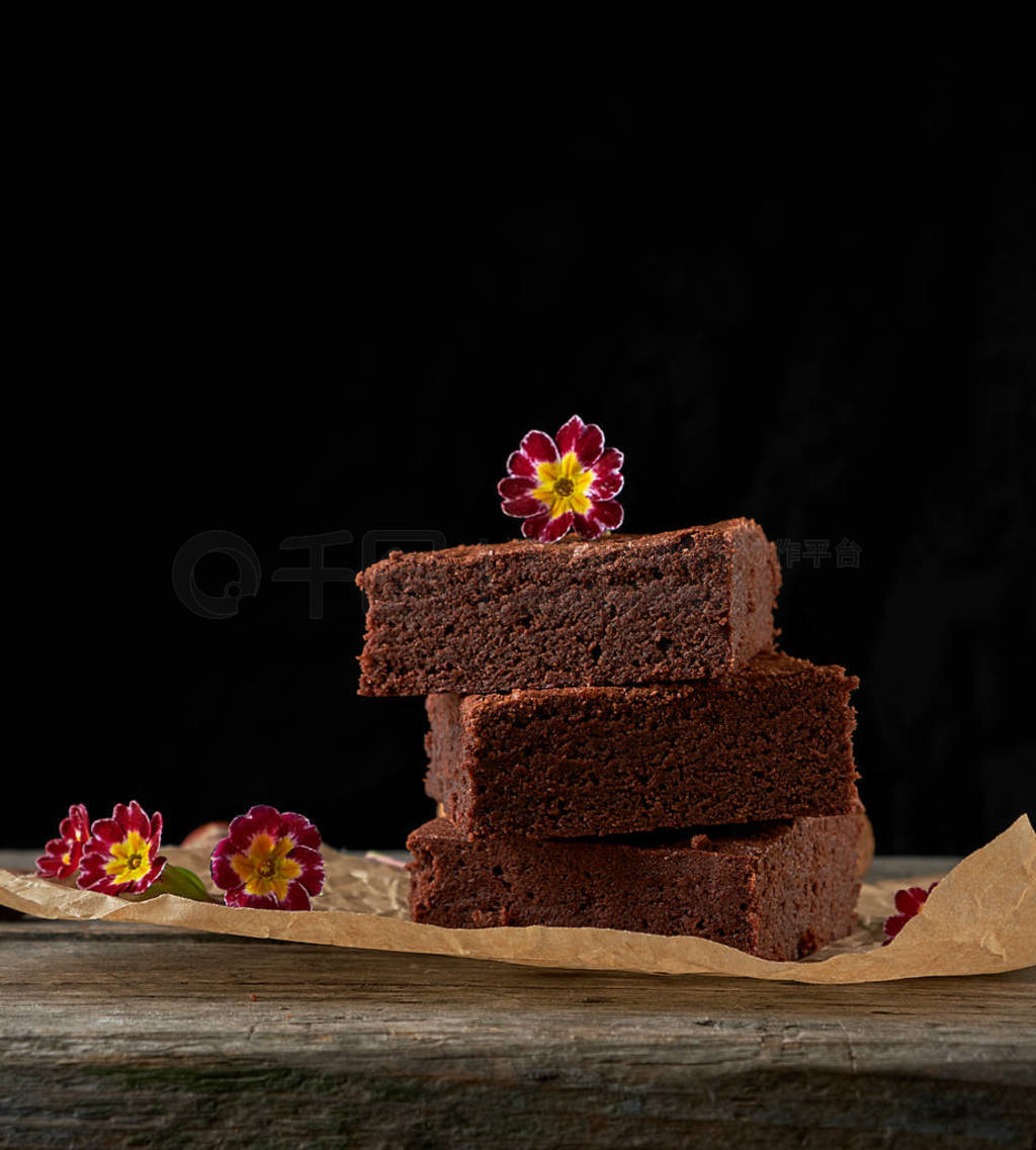 stack of baked square pieces of chocolate brownie cake