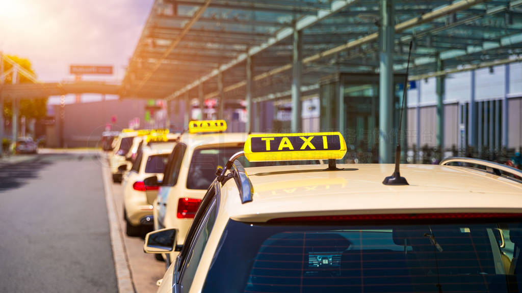 Taxi cabs waiting for passengers. Yellow taxi sign on cab cars.