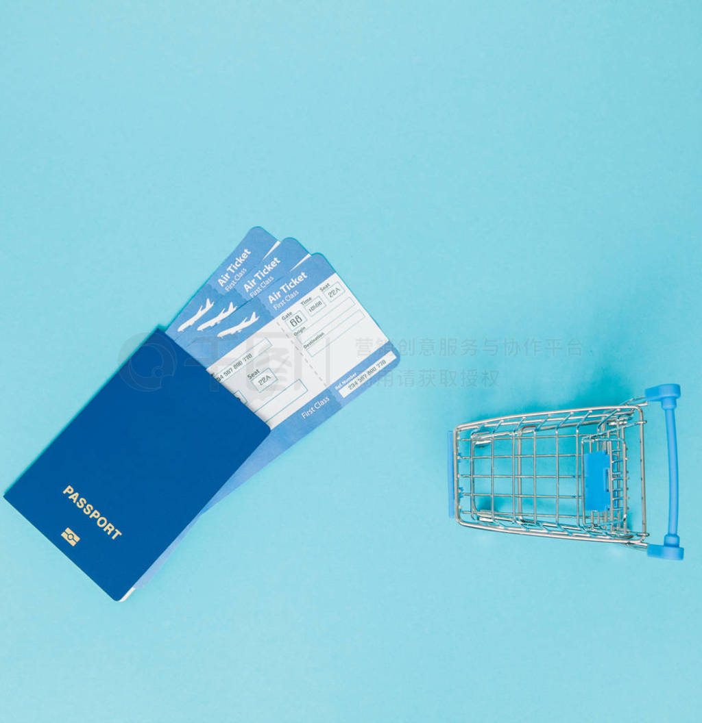 Tickets for airplanes and passport, and shopping cart on a blue