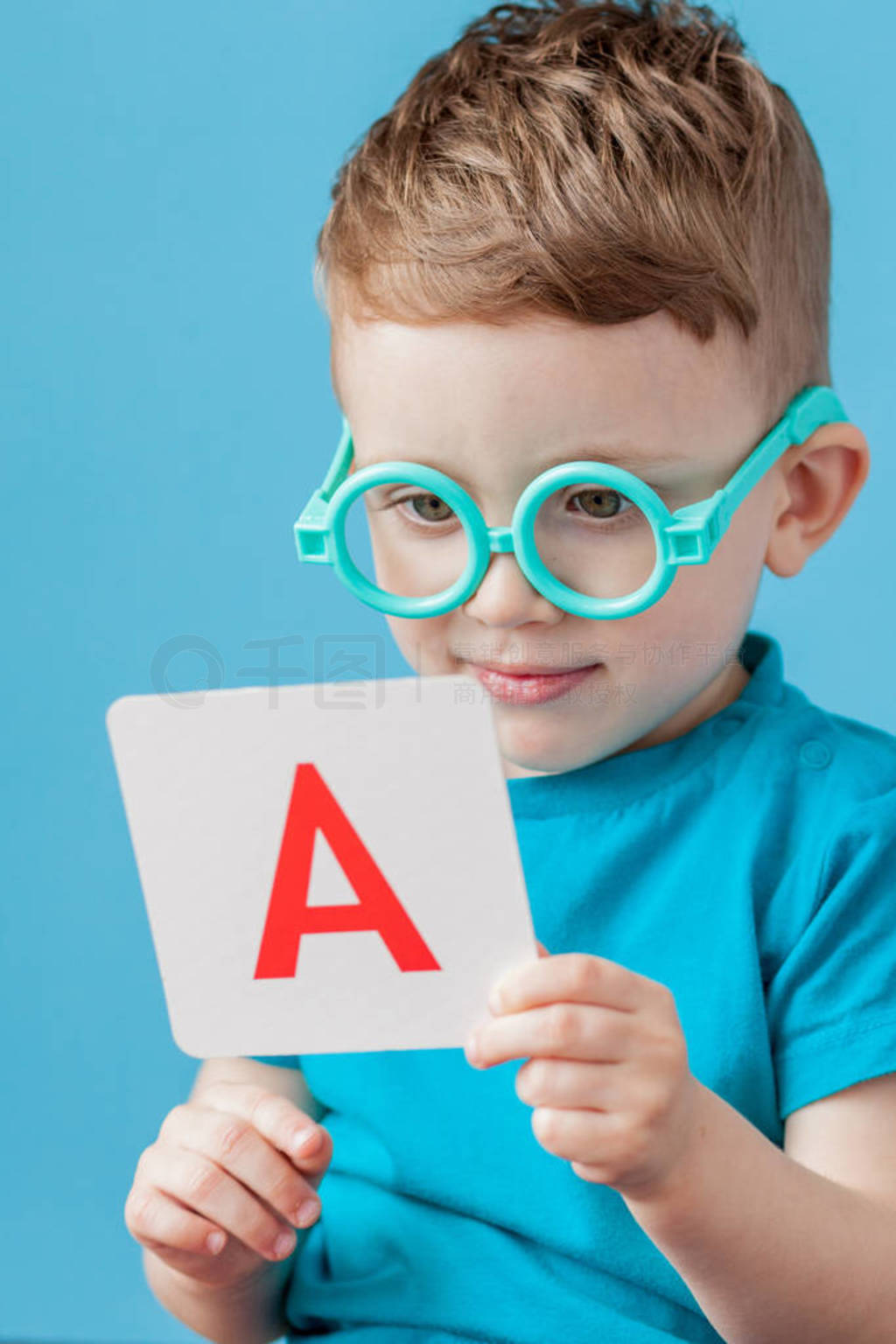 Cute little boy with letter on background. Child learn letters.