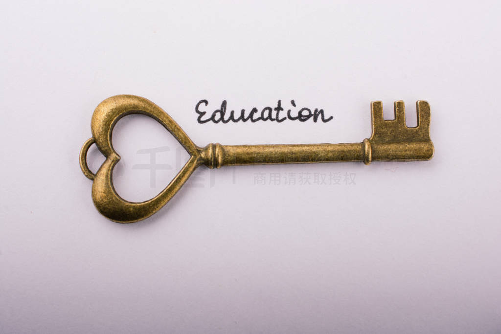 Education wording beside a retro style key on white background