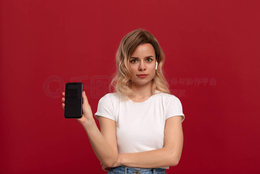 Portrait of a girl with curly blond hair in a white t-shirt on a