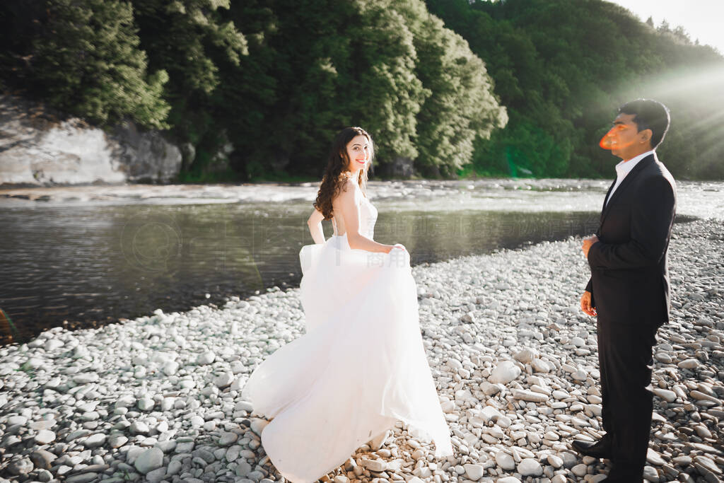 Elegant stylish happy blonde bride and gorgeous groom on the bac