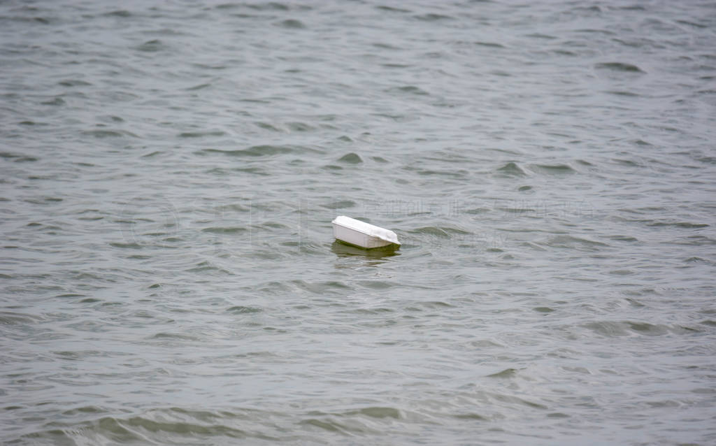 Plastic Stryfoam floating on beach water. Environmental problem
