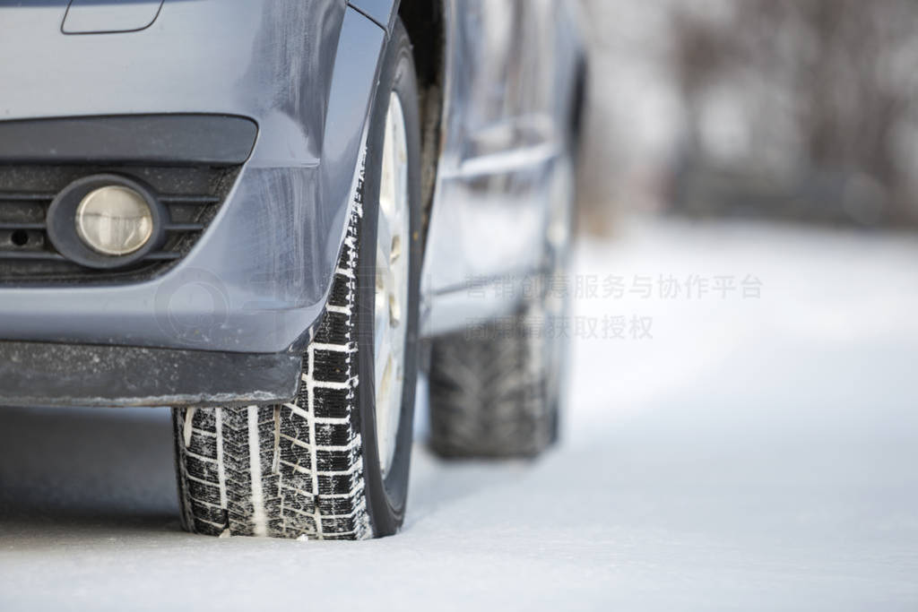 Close-up of car wheels rubber tire in deep snow. Transportation