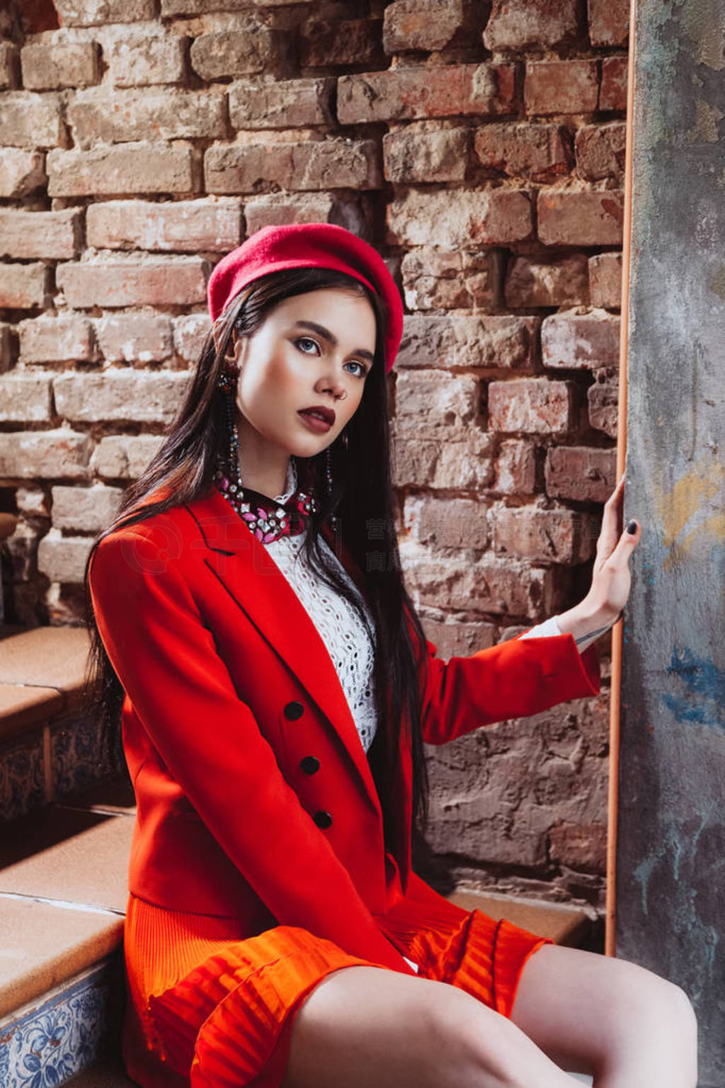 very beautiful brunette model on a brick wall background