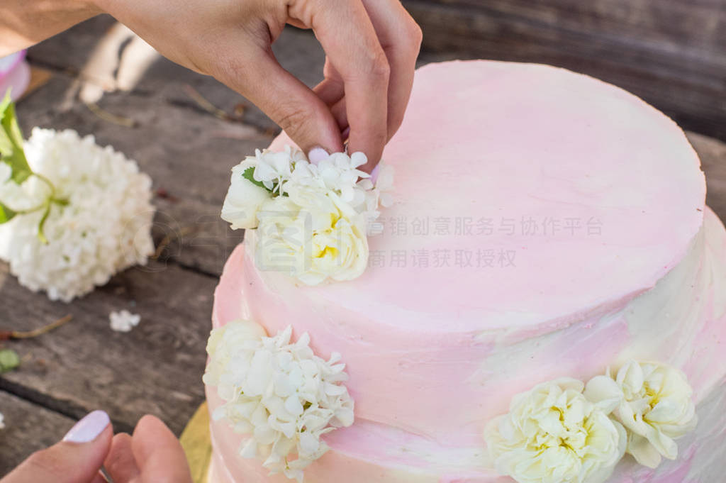 Process of decorations of big pink wedding cake