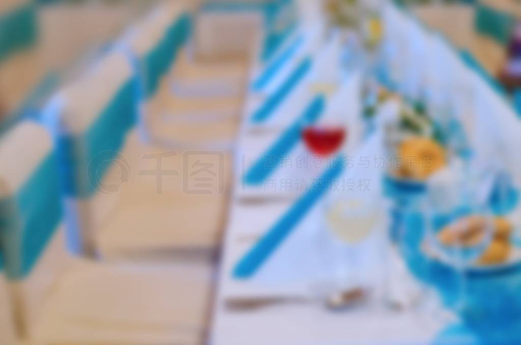 Blurry scene of prepared table and chairs for wedding.