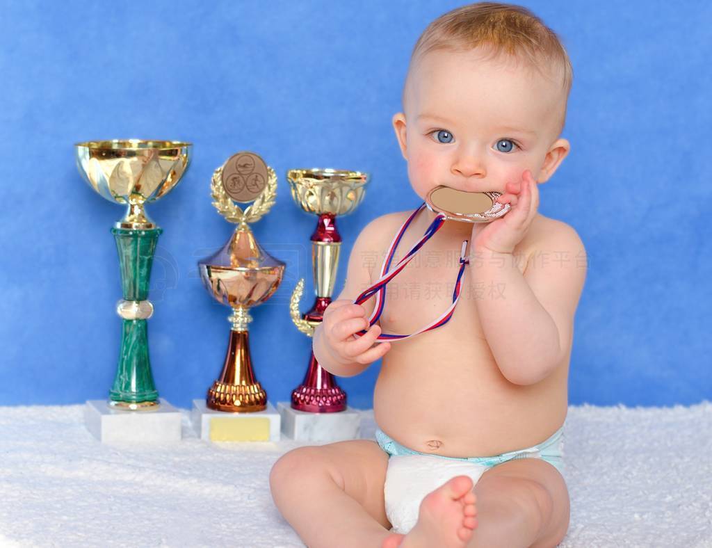 Little winner. Cute toddler wearing diaper and holding a medal.