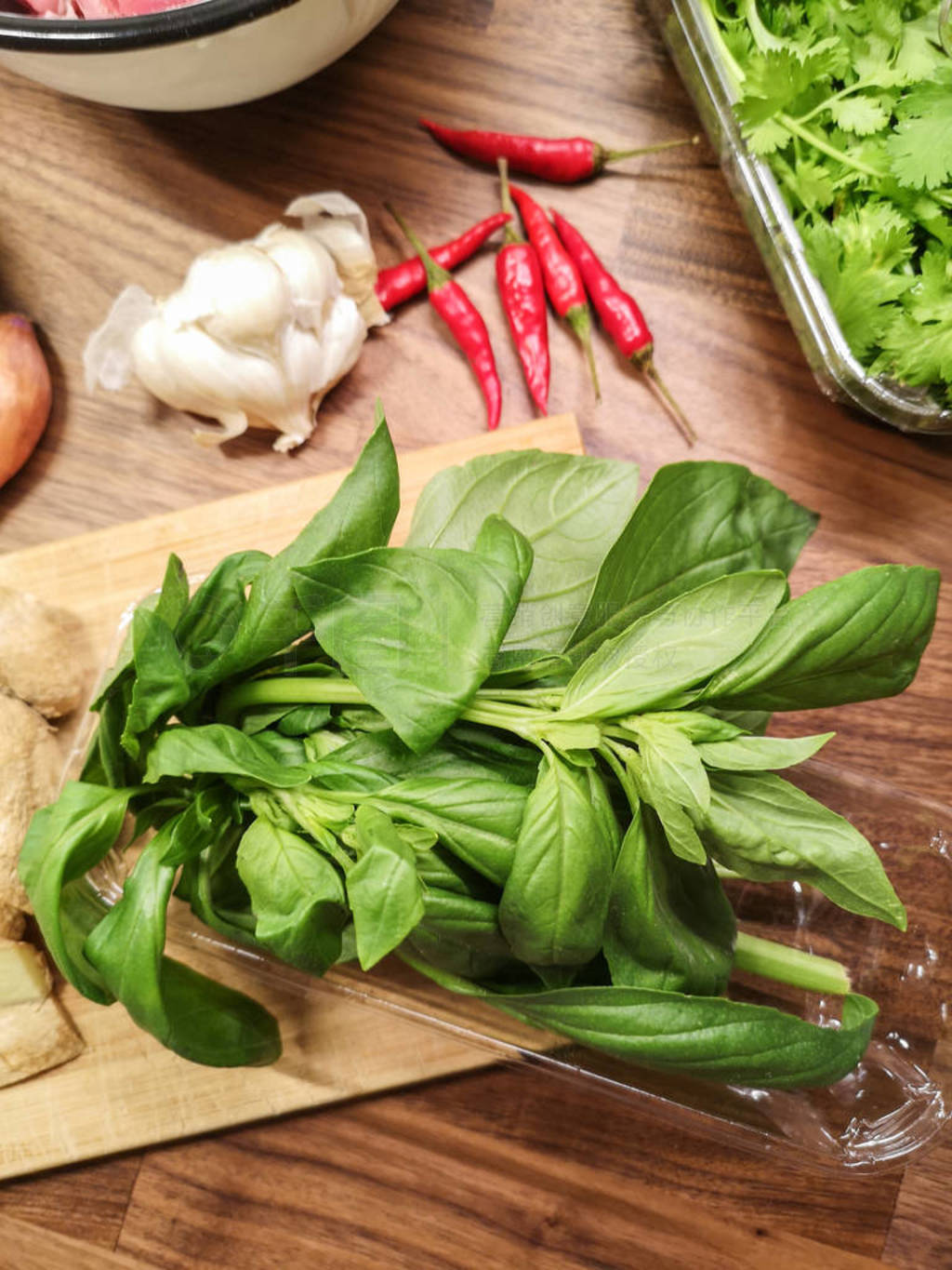 cooking Asian dish,closeup on basil leaves