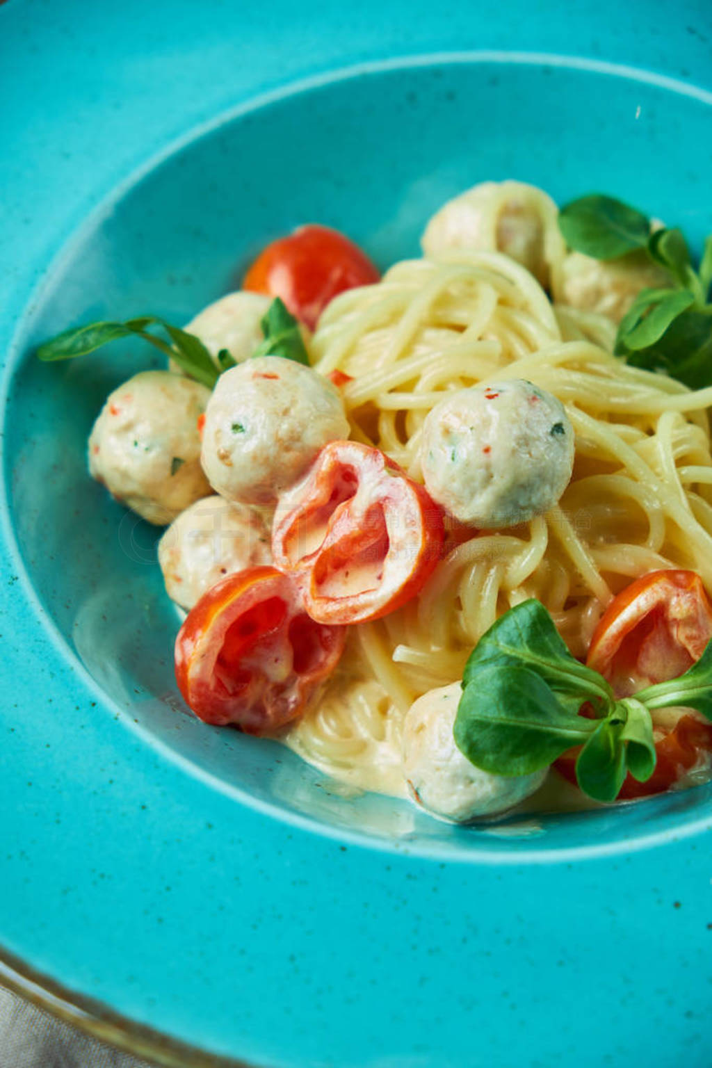 Childrens pasta with meatballs and basil among childrens toys