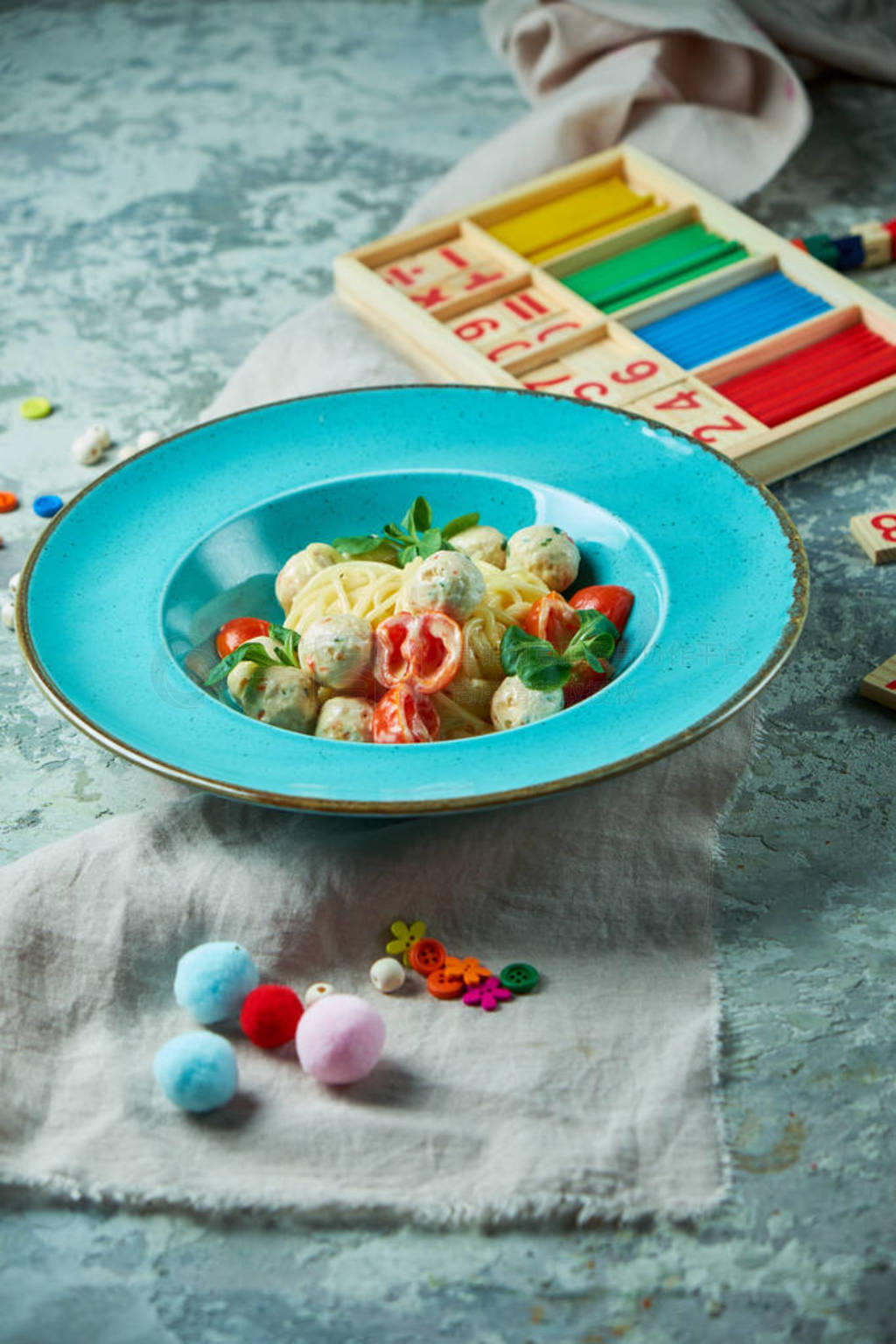 Childrens pasta with meatballs and basil among childrens toys