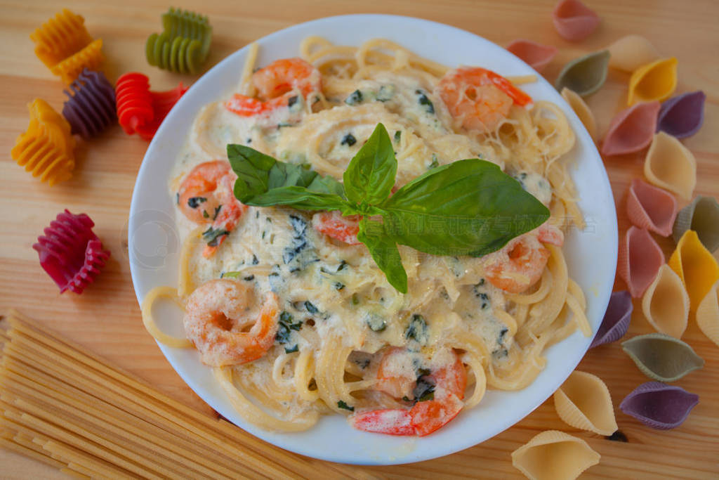 delicious delicious spaghetti with shrimps and basil on plate