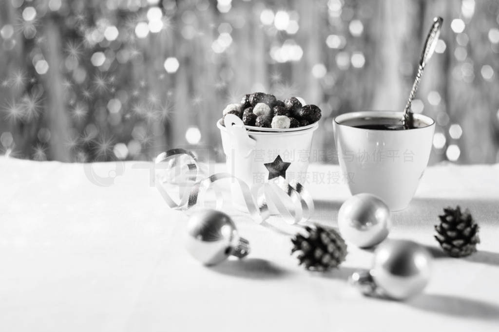 A cup of cocoa with marshmallows and corn balls in the New Year