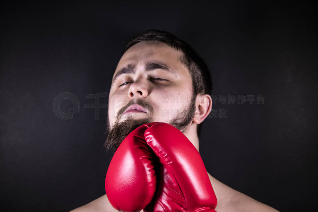 Boxer in red gloves for boxing strikes the opponent to the man.