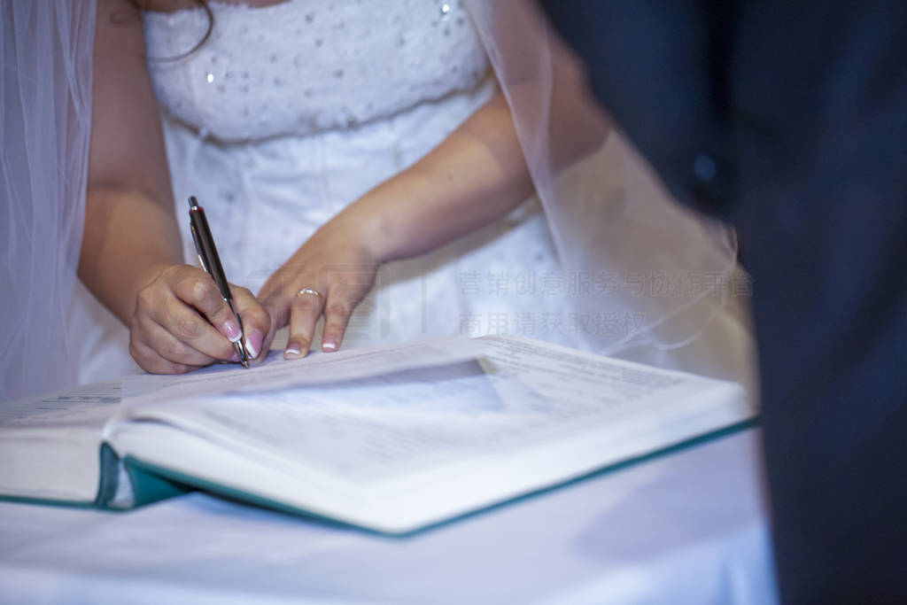 bride signs wedding deed in Christian marriage