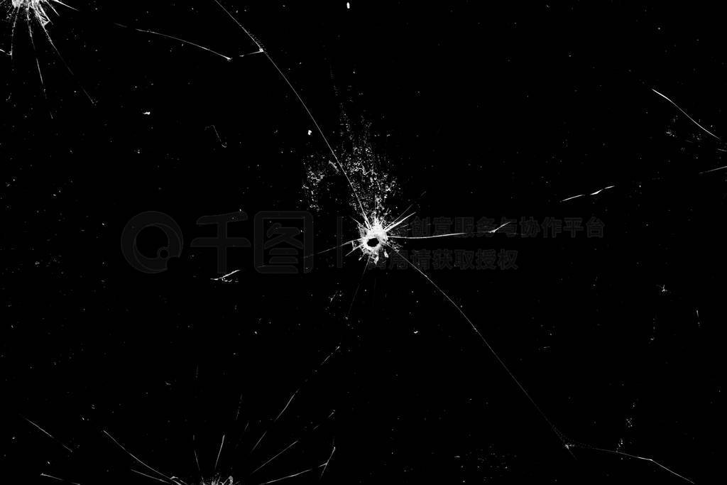 holes in the glass with cracks isolated on a black