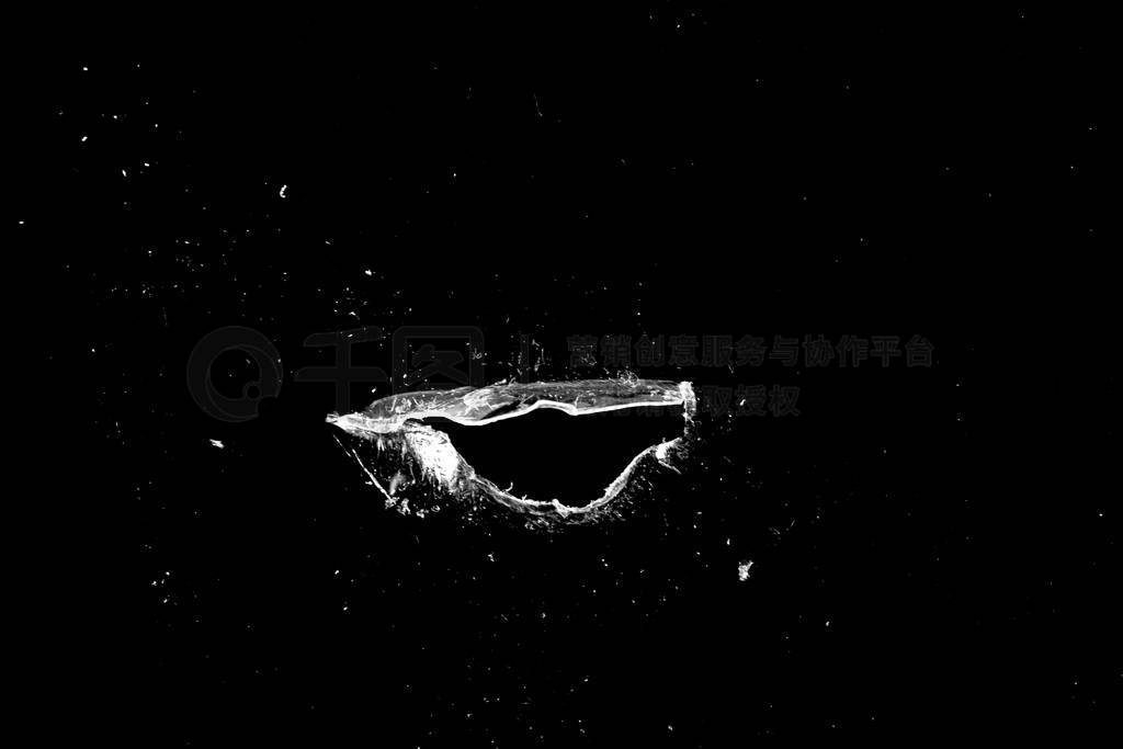 hole in the glass with cracks isolated on a black background.