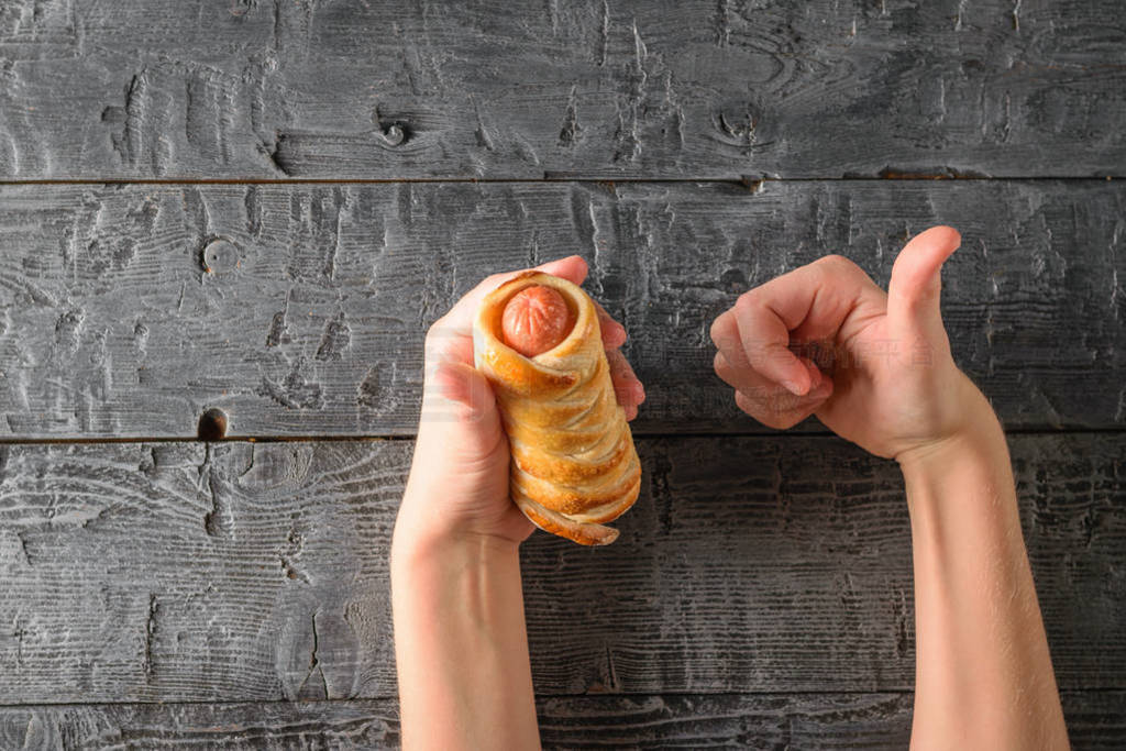 s hands gestures show the taste of homemade sausage in the dough