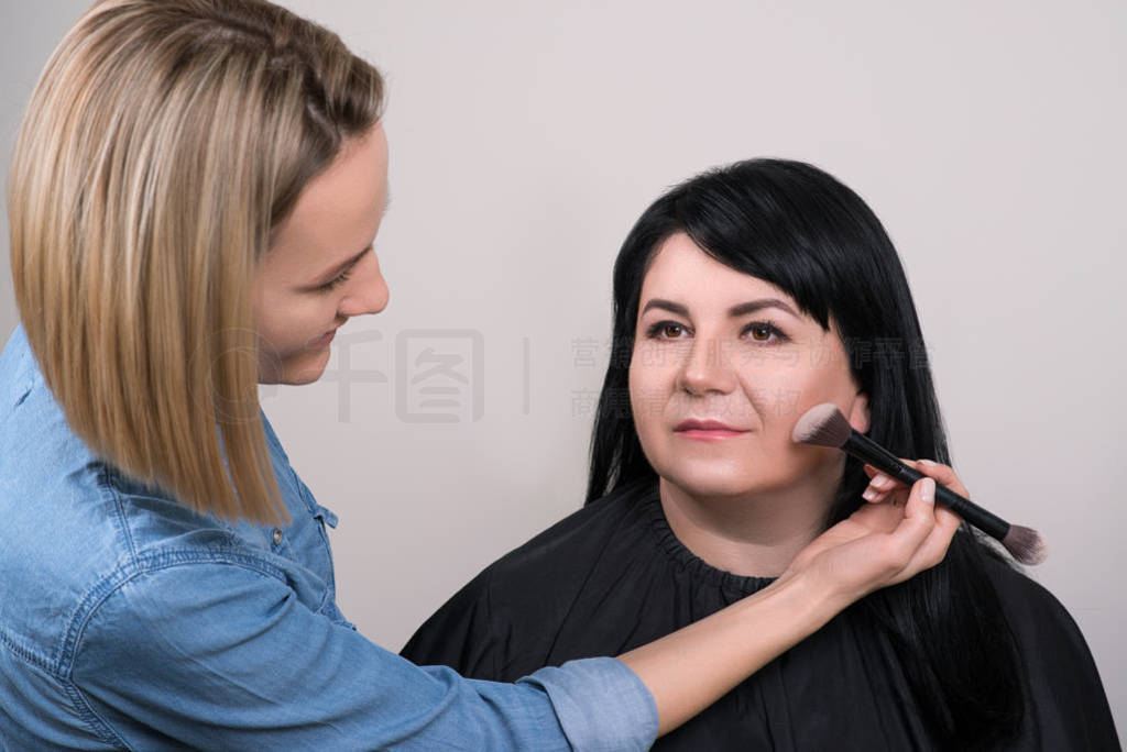 Make up artist doing professional make up. Beauty salon concept.