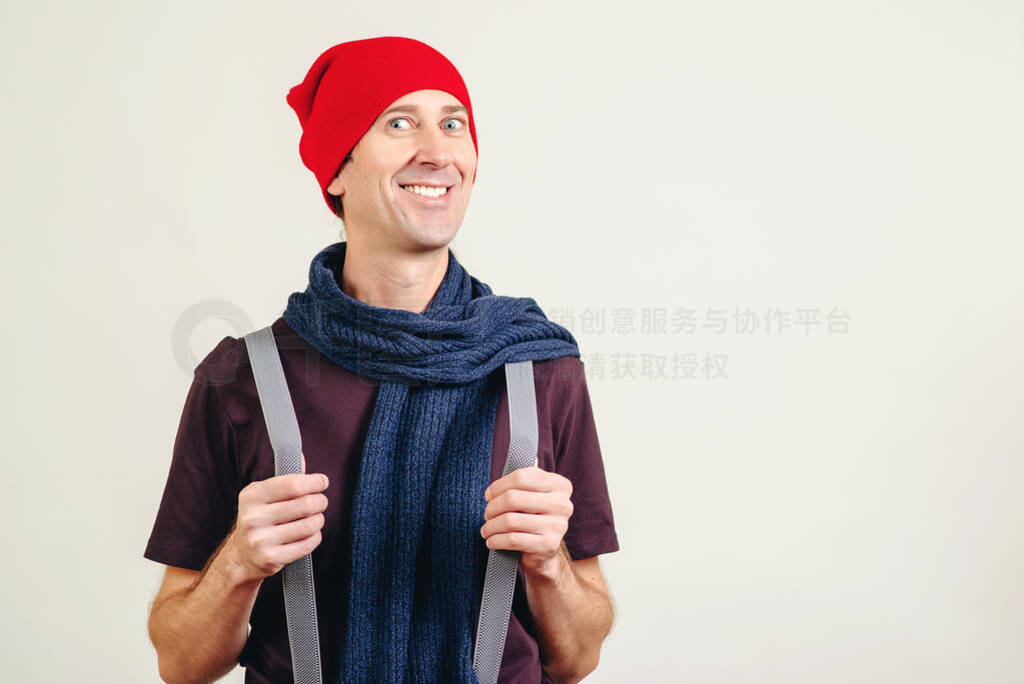 Funny nerd guy pulling his suspenders. Trendy hipster in hat and