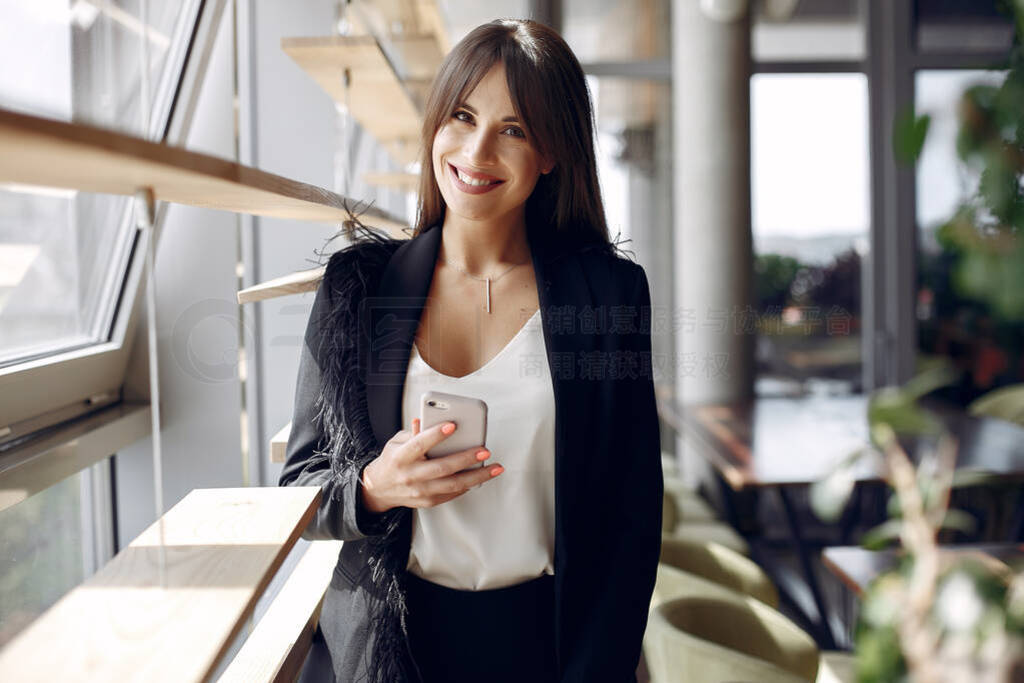 Elegant businesswoman working in a office and use the phone