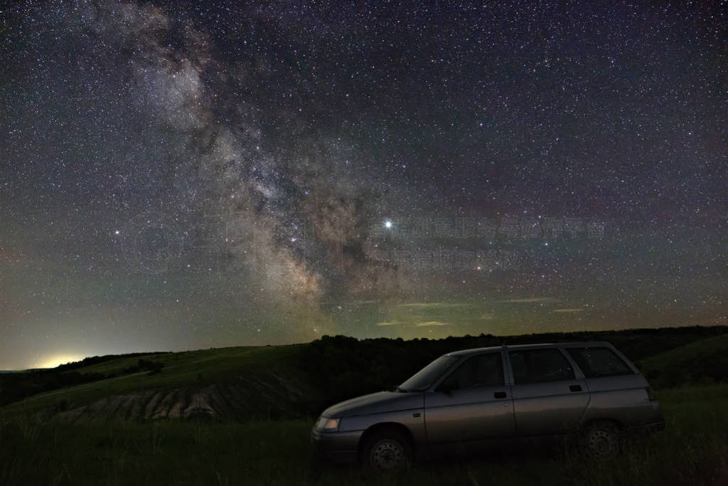 View of the Milky Way over the car travelers. Bright stars