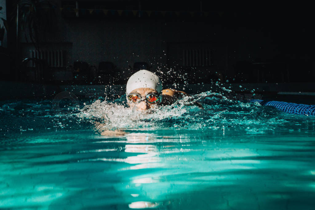 Professional woman swimmer swim using breaststroke technique on
