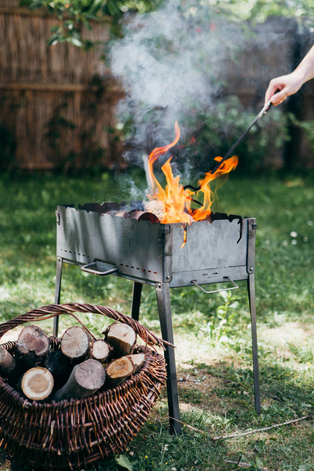 Flaming barbecue grill in the yard in summertime